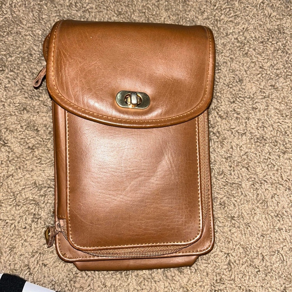 A wallet that has a cross body.  leather